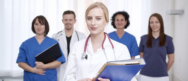 A doctor together with another doctor and nursing staff