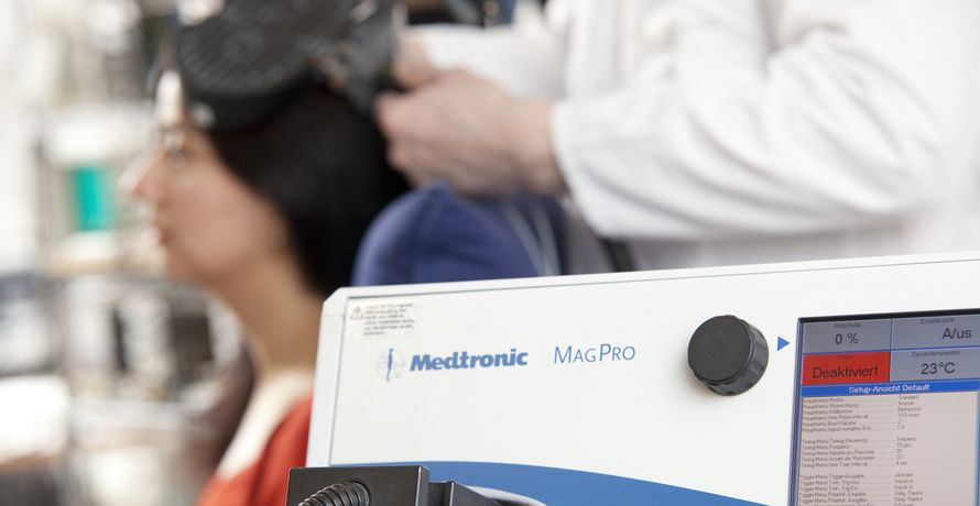 Image of magnetic stimulator with test person in the background